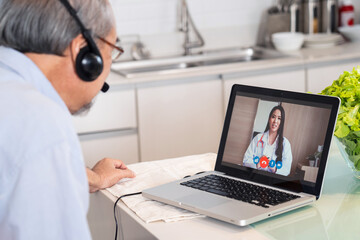 Senior grandfather patient telemedicine video call with doctor at home
