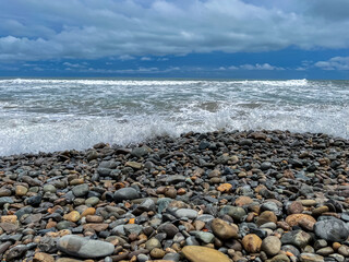 Beautiful closeup view of the Dominical Beach shore field with rocks in Costa Rica