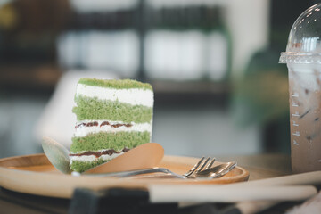 Triangle pandan layer cake filled with cream and red beans