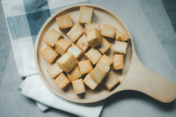 A pile of diced fish tofu place in wooden plate