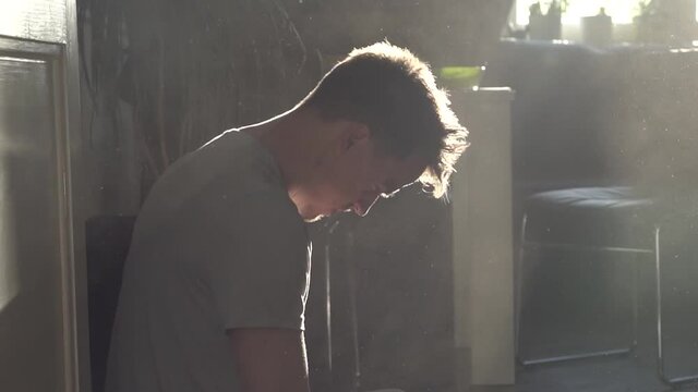 A man coughing in a dusty environment.