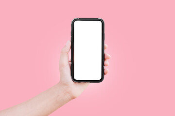 Close-up of male hand holding smartphone with mockup isolated on background of pink color.