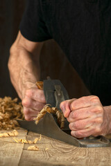 Joinery. Planing a natural oak wood furniture board with a manual planer