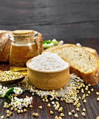 Flour buckwheat green in bowl with bread on table