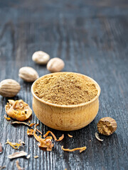 Nutmeg ground in bowl on dark wooden board