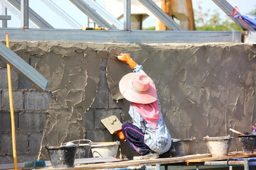 worker put on cement on wall  new buiding construction site
