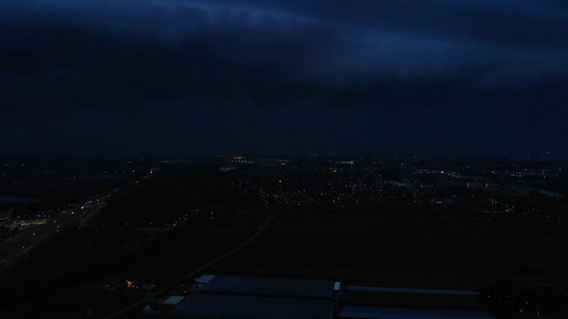 Flash Of Lightning Flickers Into The Sky Over The City. wide shot