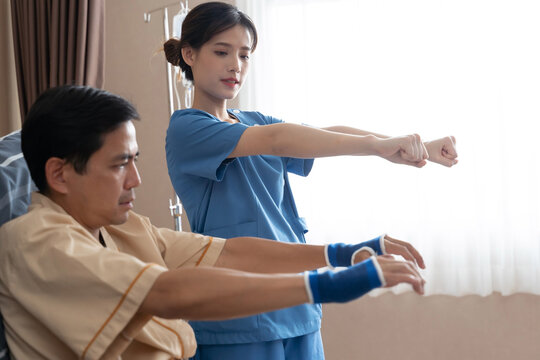 Asian nurse therapists  stretching arm muscles treatment of physiological.