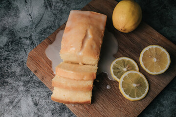 Lemon pound cake with slices of lemon sugar icing. Delicious breakfast, traditional tea time treat. Reciepe of English lemon pie loaf.