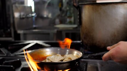 Chef preparing ravioli with tomatoes sauce in restaurant, close-up, Mediterranean - Powered by Adobe