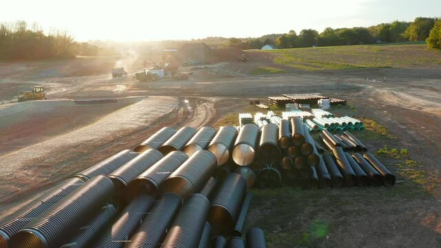 Pipes at ground excavation site. Earth grading and water sewer management as site is prepared for housing and new road in Lititz Pennsylvania USA.