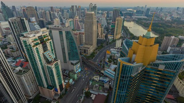 Time lapse of aerial view of Asoke intersection or junction with cars traffic, Bangkok Downtown. Thailand. Financial district in smart urban city and technology concept. 