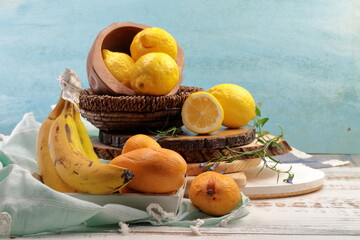 Yellow colored fruits still life which inclused, Banana, Lemons and Mangoes