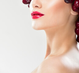 Beautiful woman in hat of red berries. Juicy cherries.