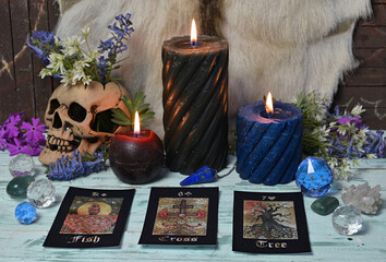 Still life with tarot cards, burning candles and magic objects on witch table. Esoteric, gothic and...
