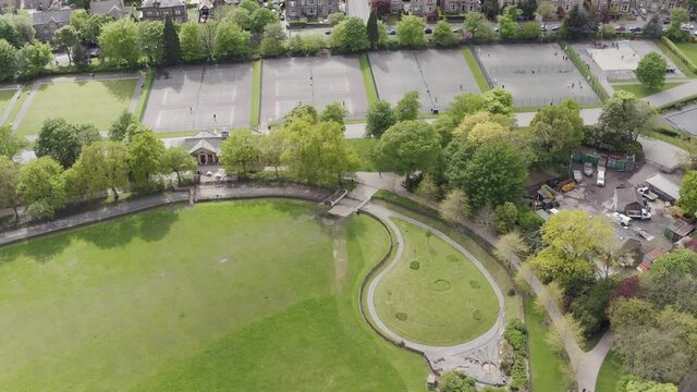 Aerial drone shot flying over English tennis courts in rural countryside town