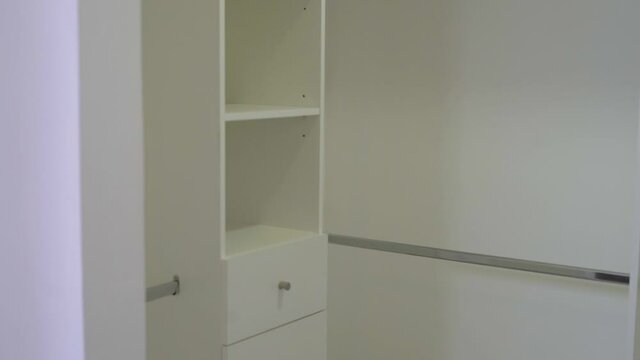 empty white walking closet in the bedroom to place clothes in