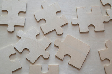 wooden puzzle pieces lying scattered on the floor.