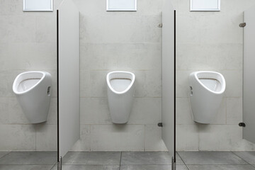 Row of urinal toilet blocks in men public toilet or restroom