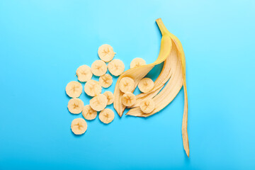 Creative composition with cut banana on color background
