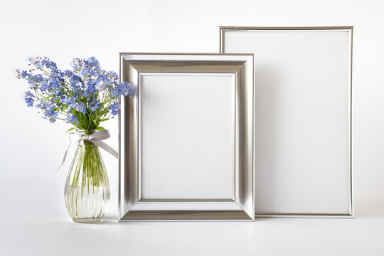 Minimalist Stylish Modern Composition Mockup Template With Two Silver Blank Frames And Blue Wild Flowers In A Glass Vase.