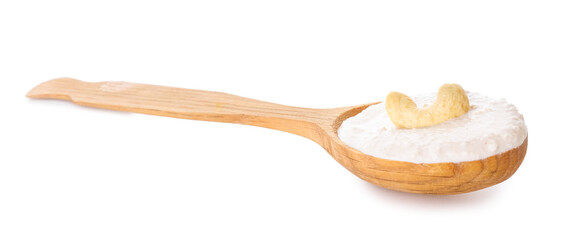 Spoon with cashew sour cream on white background