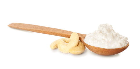 Spoon with cashew sour cream on white background