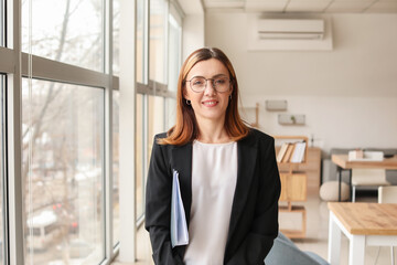 Fototapeta premium Female accountant with folder in office