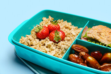 Lunchbox with tasty food on color background
