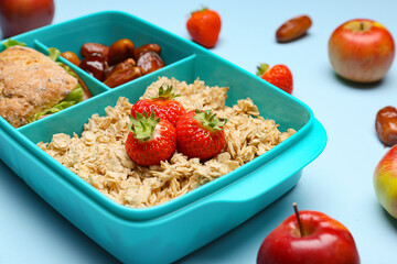 Lunchbox with tasty food on color background