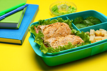 Lunchbox with tasty food and stationery on color background