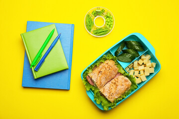 Lunchbox with tasty food and stationery on color background