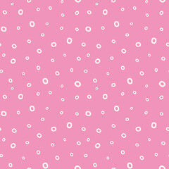 Dotted background pattern. Abstract pink vector seamless repeat of hand drawn dots in a randomised design. 