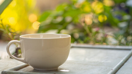 White coffee cup on nature background.