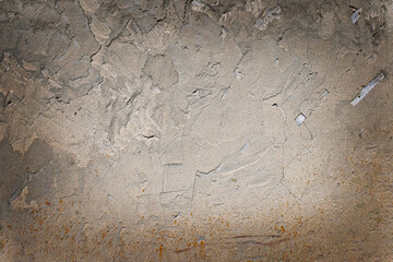 .Plastered wall of an old house with traces of weathering. Uneven gray surface. Grunge. Texture. Background. Copy space.