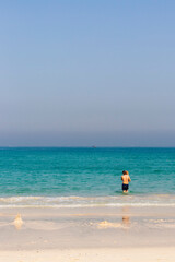 Obraz premium Teenage boy carrying little girl at the beach. Holiday