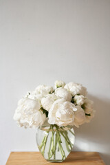 White peonies in a glass vase. Beautiful peony flower for catalog or online store. Floral shop concept . Beautiful fresh cut bouquet. Flowers delivery