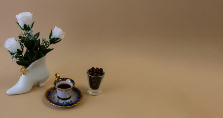 .coffee, flowers, candles on a beige background as a symbol of home warmth and coziness