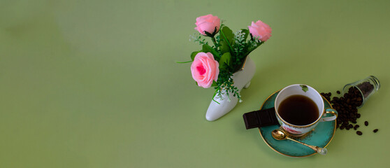 coffee, flowers, candles on a pistachio background as a symbol of home warmth and coziness, beauty and a wonderful morning