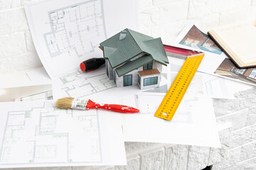 building house on blueprints with worker - construction project