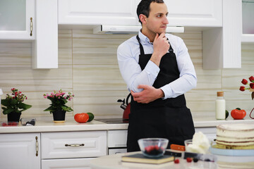 Master pastry chef in front of a desk. Cooking desserts at home. The Armenian man is engaged in confectionery.