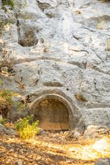 Obraz premium Sarcophagus or rock tombs in ruins of the ancient city of Termessos without tourists near Antalya, Turkey