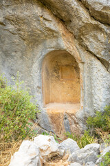 Sarcophagus or rock tombs in ruins of the ancient city of Termessos without tourists near Antalya, Turkey