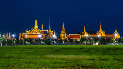 Naklejka premium Golden Night light of Wat Phra Kaew (View from the lawn or Sanam Luang), grand palace or Temple of the Emerald Buddha .