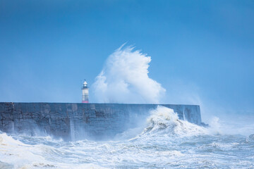 Crashing waves and stormy waters at Newhaven Lighthouse East Sussex, south east England