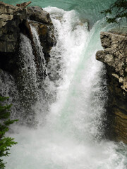 beautiful  turquoise-colored waterfall in johston canyon in banff national park, alberta, canada