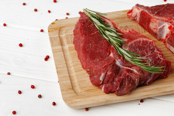 Beef tenderloin on wooden board on wooden table