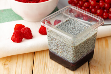 Chia seed pudding with berries on wooden table