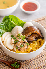 Bak chor mee. The noodles are tossed in vinegar, minced meat, pork slices, pork liver, stewed sliced mushrooms, meat balls and bits of deep-fried lard
