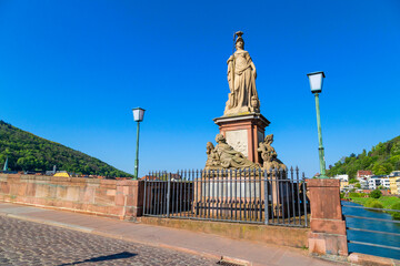 The Alte Brucke (old bridge) is an arch bridge in Heidelberg that crosses the Neckar river. - obrazy, fototapety, plakaty